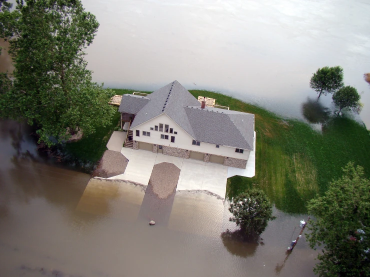 a flooded house with a large lawn on it
