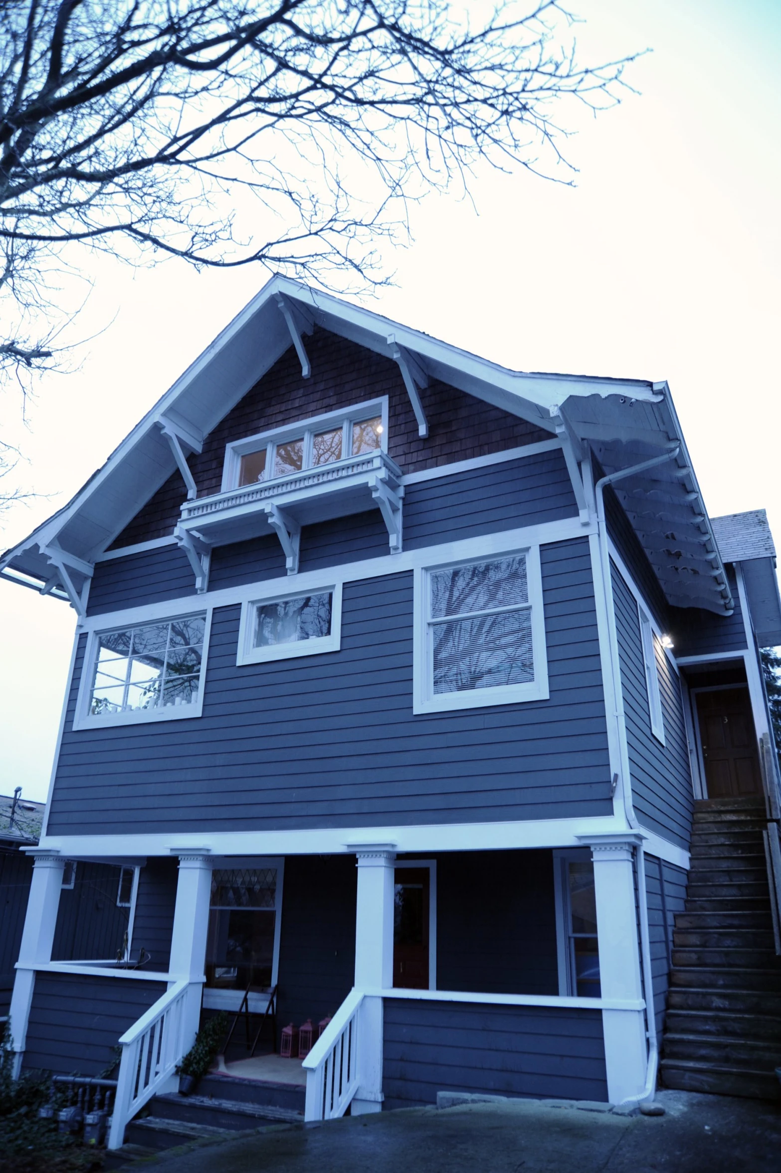 a house that has stairs leading to the front door