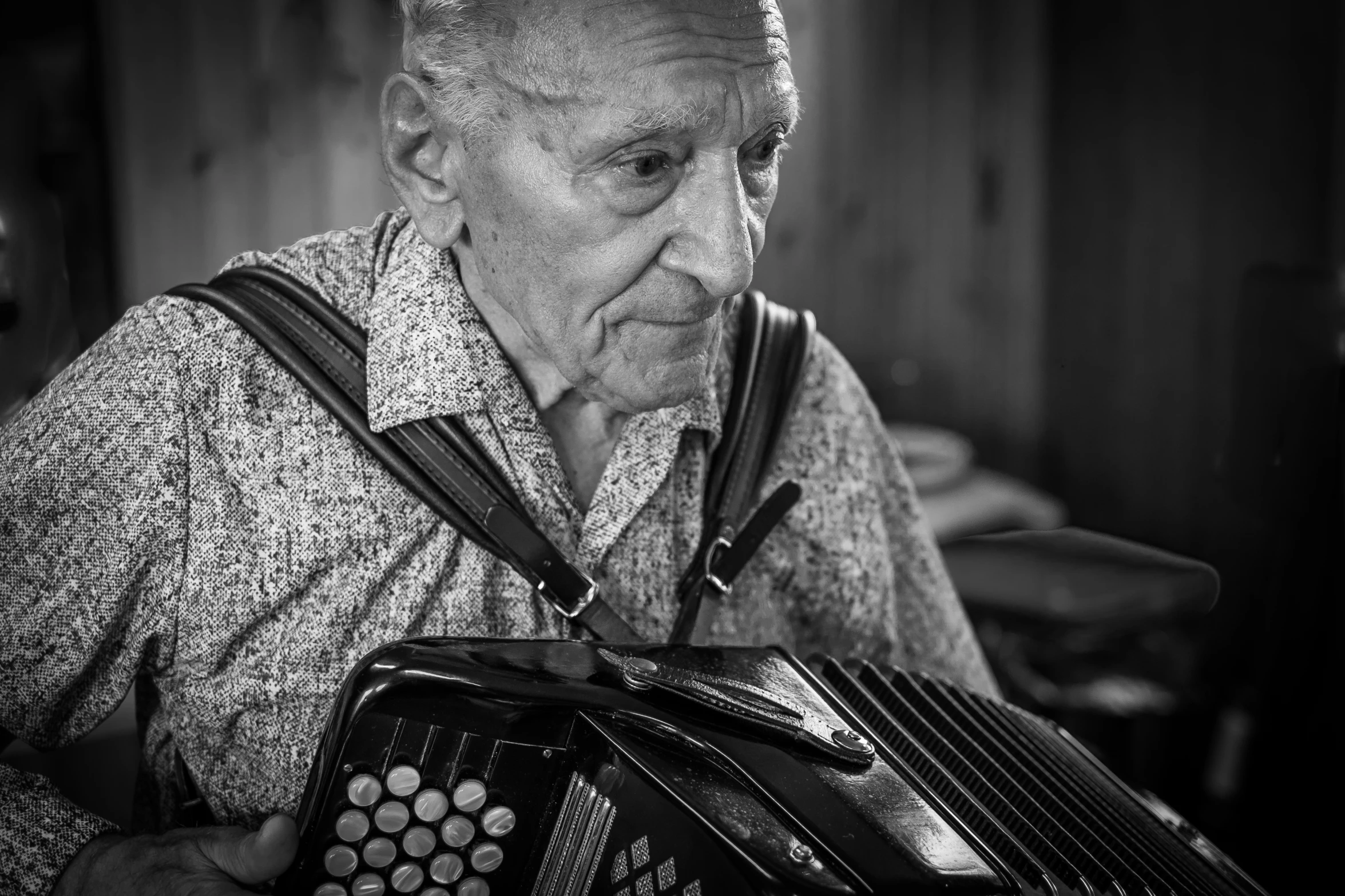 the old man is playing the accordion