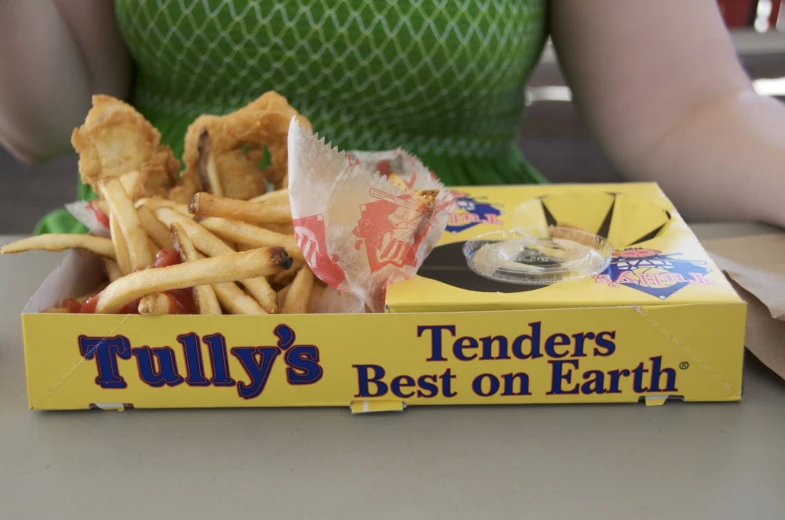 a box full of fries and french fries on a table