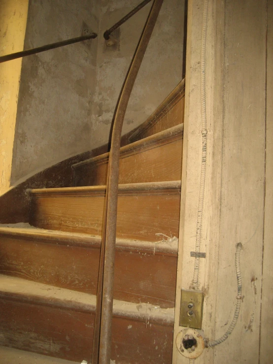 a wooden staircase with two long ties attached