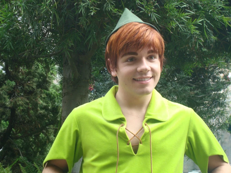 a  with a party hat wearing a green shirt