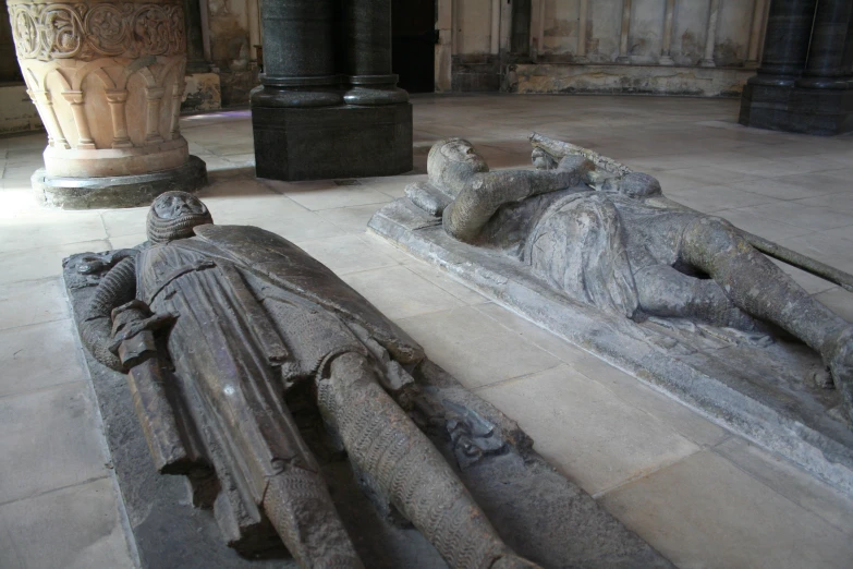 an ancient sculpture in the middle of a room with columns and statues