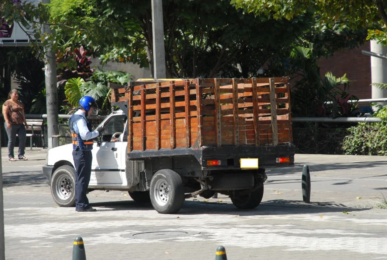 the person is repairing the truck with a helmet