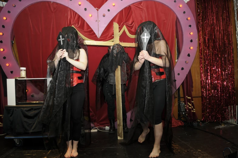 a man and woman are standing on stage in front of giant mirrors