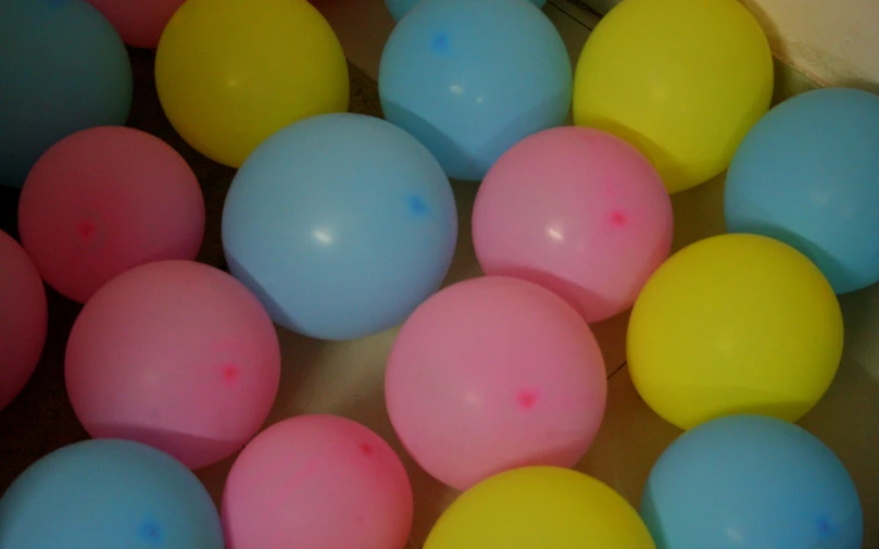 several multicolored balls are scattered on the floor