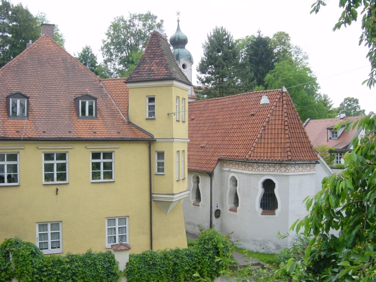 an old house with several chimneys and small windows