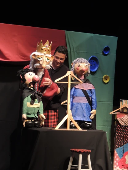 a couple of people on stage that have puppets