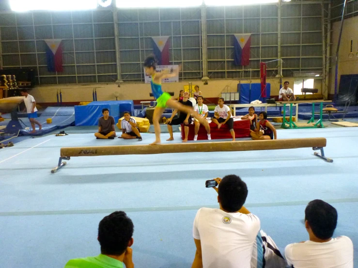 people sit on the floor watching a person in the middle of the performance