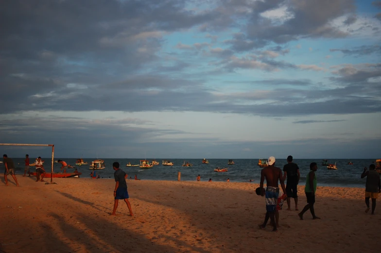 a group of people standing on top of a beach