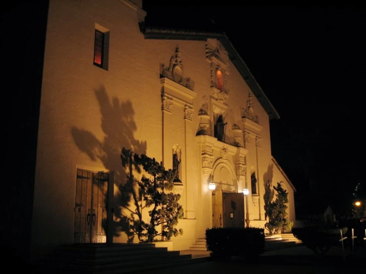 the front of an old church lit up at night