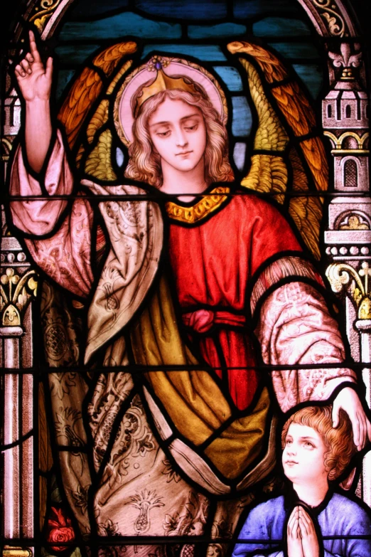 an angel stained glass window depicting a man with hands raised