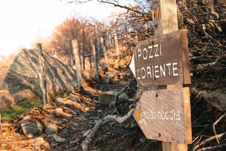 a wooden sign points the way out towards a rocky area