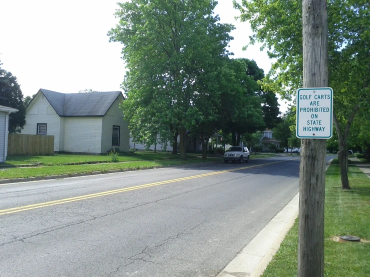 a white house sitting on the side of a street