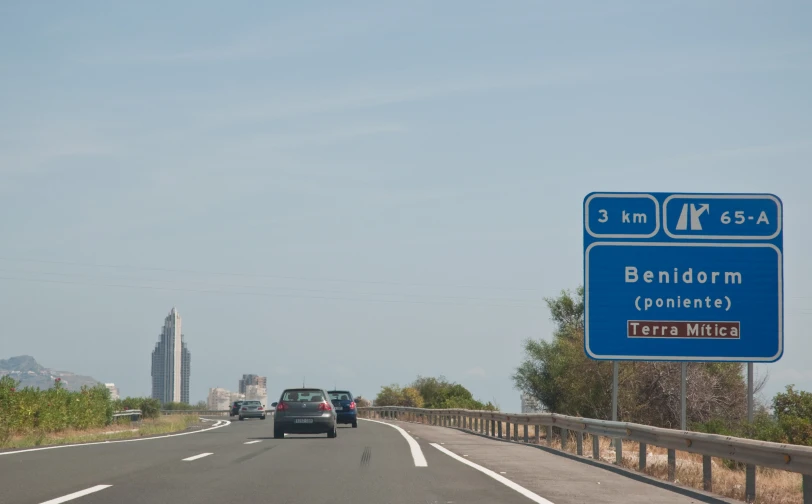 a large blue sign over an empty highway