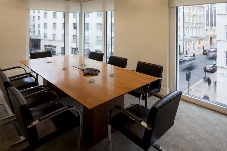 large wooden conference table in a glass walled office space