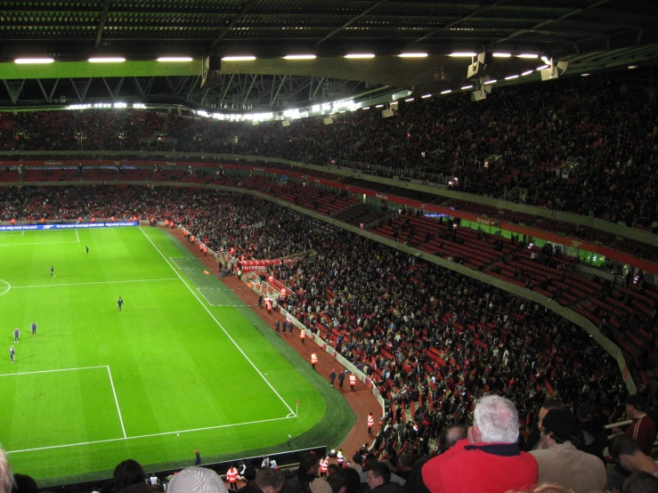 a stadium full of people and playing soccer