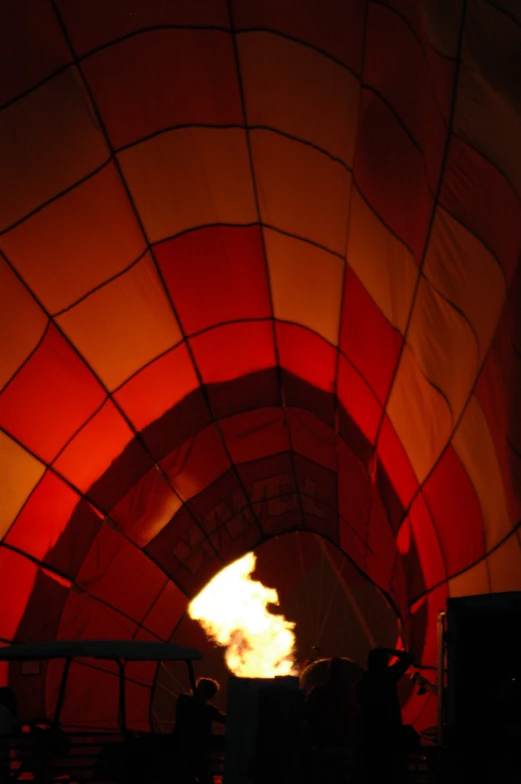 people are watching the flames in the inside of a  air balloon