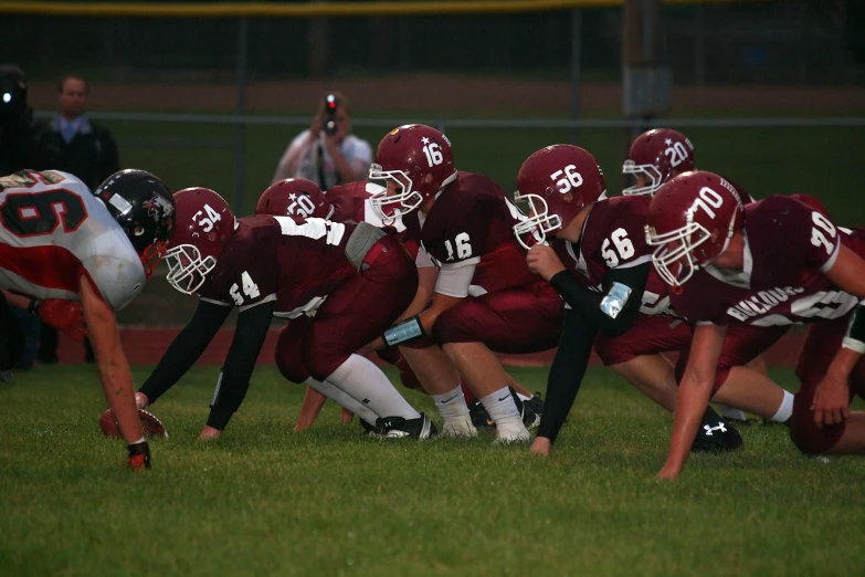 a group of football players are facing each other