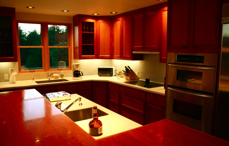 a modern, well - lit kitchen includes an oven and a microwave