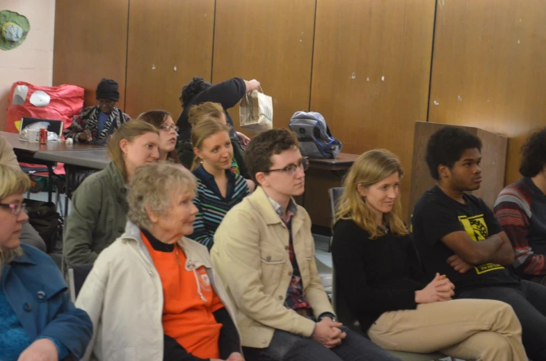 a group of people sitting on either side of a table