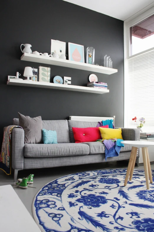 a grey couch in a very tidy looking room