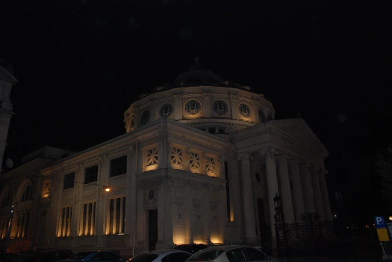 a large building sitting in the middle of a city at night