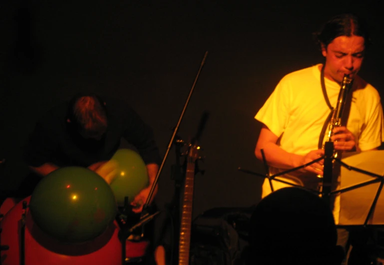 an image of a man playing a instrument at night
