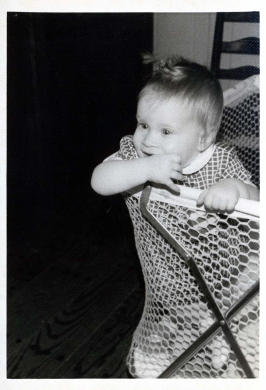 a young child holding onto a hand rail