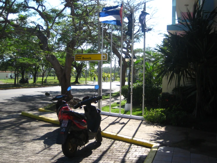 the moped rider is stopped by the stop sign