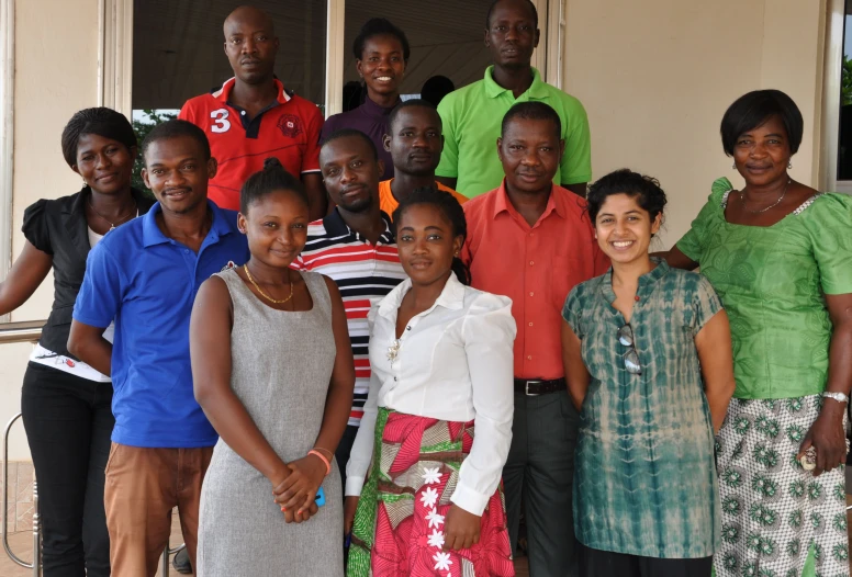 a group of people standing together in front of a door