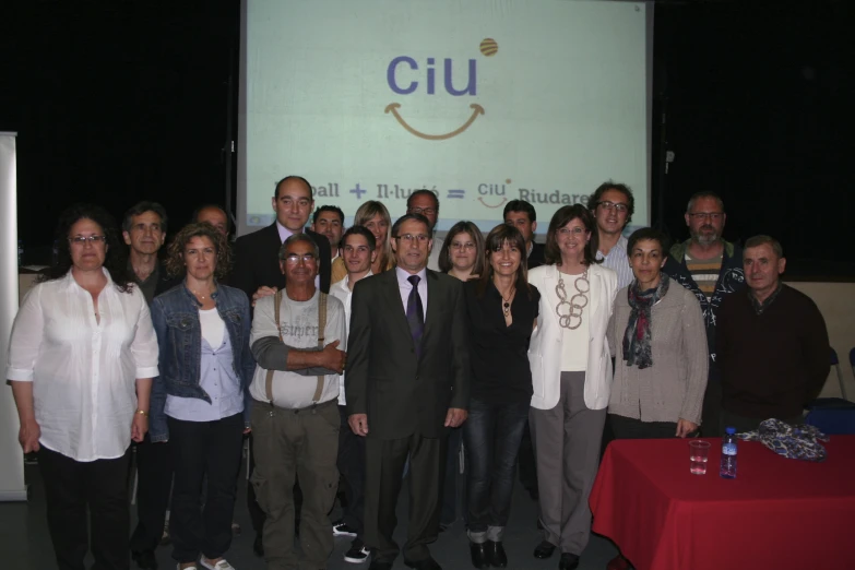 several people are standing with arms crossed and smiling