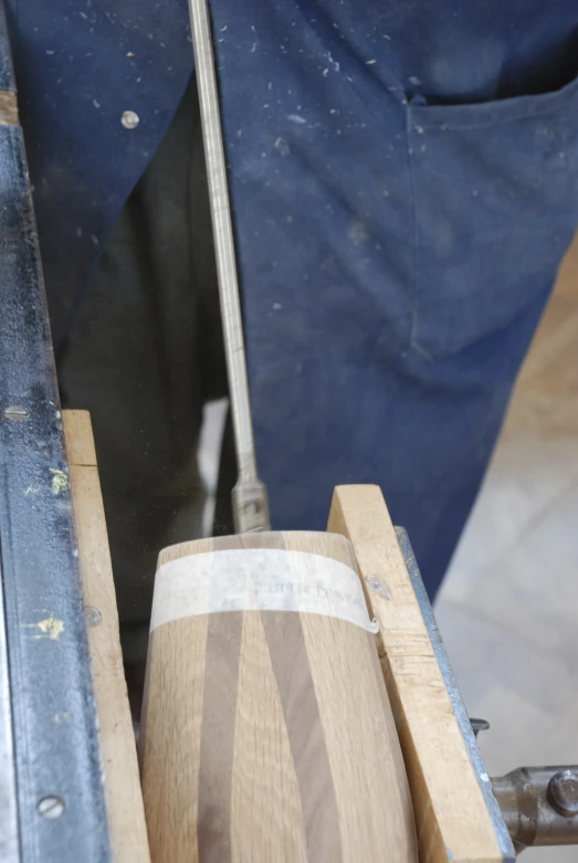 a man working with wood and other parts in his workshop