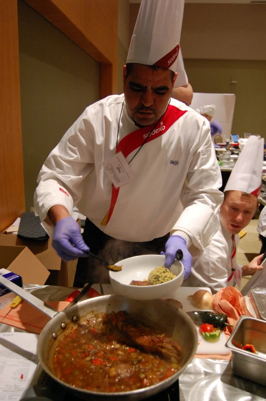 two chefs in chef outfits preparing various food