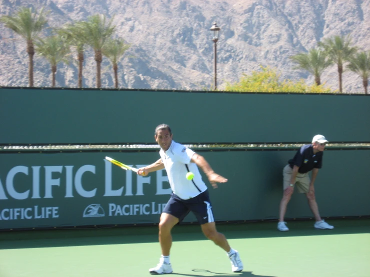 the man is playing tennis on the court