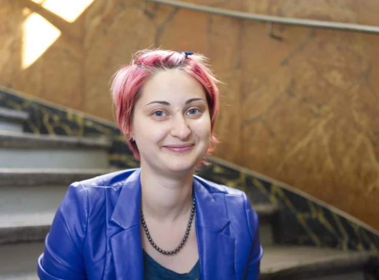 a woman is standing next to some steps