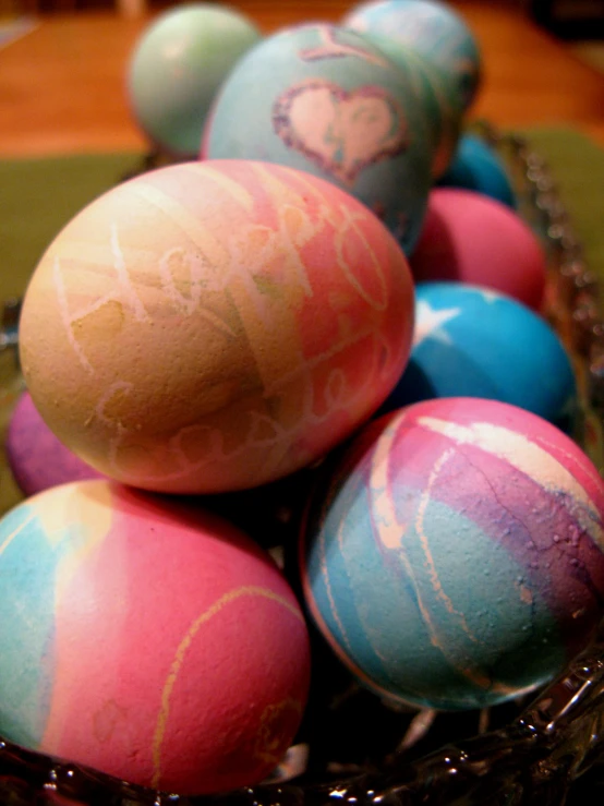 a bunch of dyed eggs in a basket