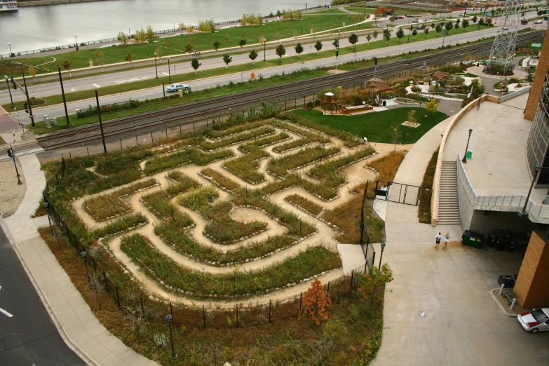 an aerial s of a giant maze by the river