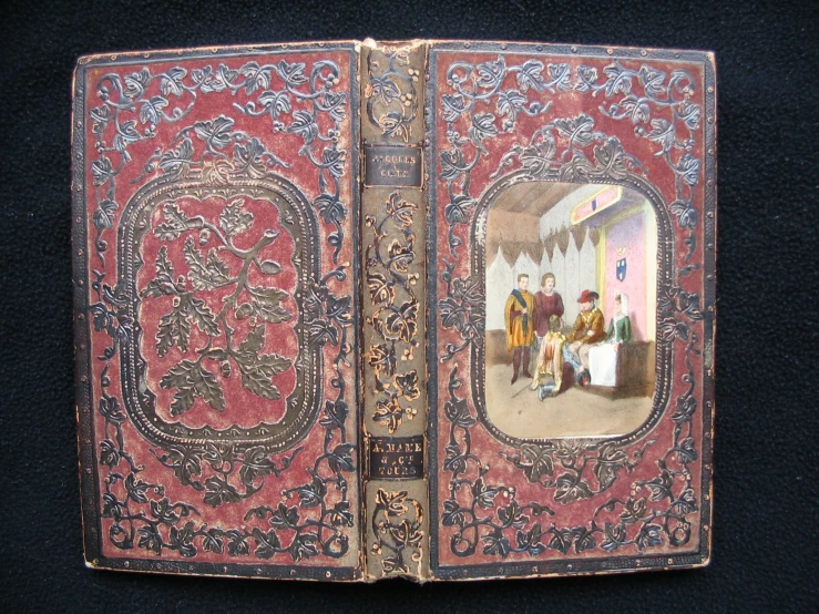 a decorative red cloth covered book with blue trim