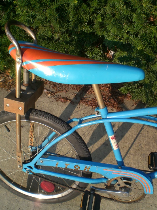 a bike with a red, blue, and yellow surfboard strapped to the back seat
