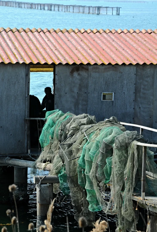 several fishing nets tied up to the docks