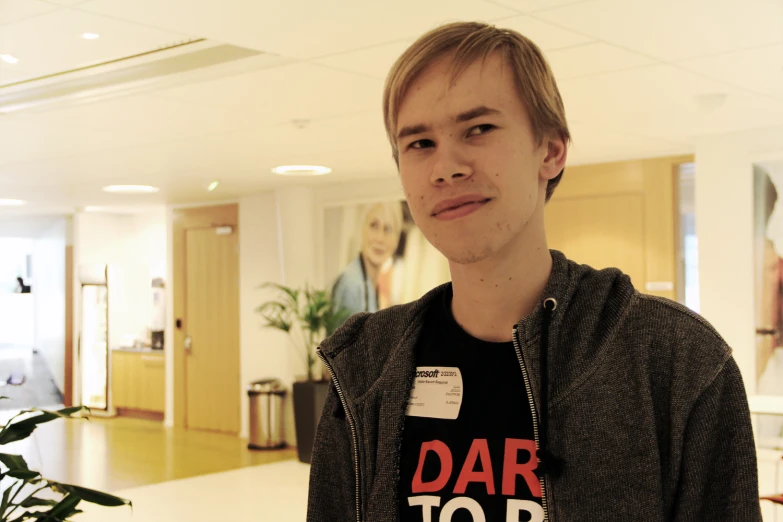 a person with a tag on his shirt next to a table