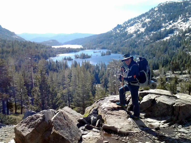 a man that is on some rocks near a river