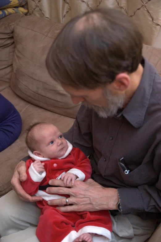 man holding his baby and holding another infant