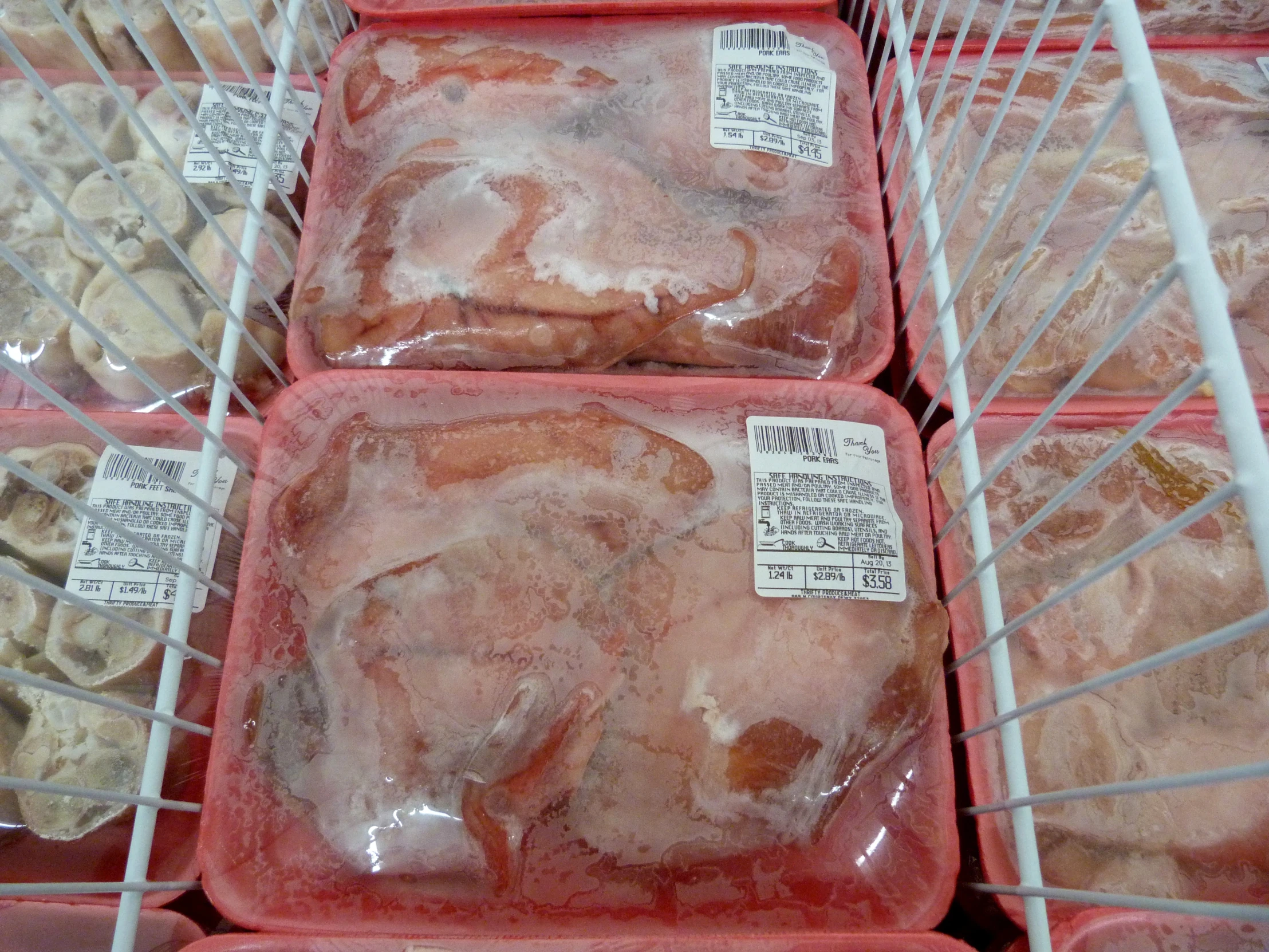 food in pink containers with labels on them