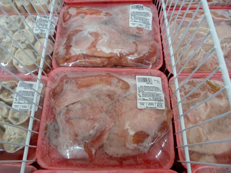 food in pink containers with labels on them