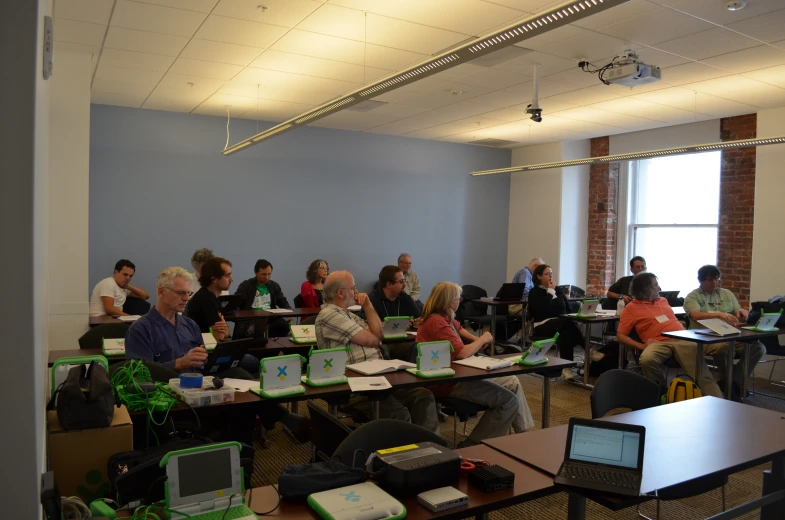 an office classroom filled with people working on computers