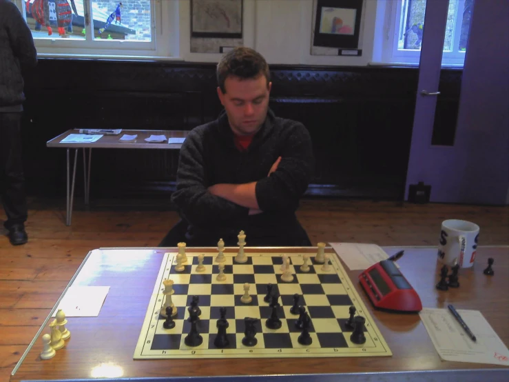 a man sitting at a table playing chess