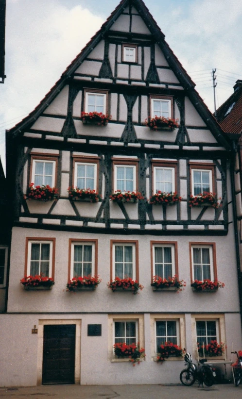 an old building with many window boxes and flower boxes