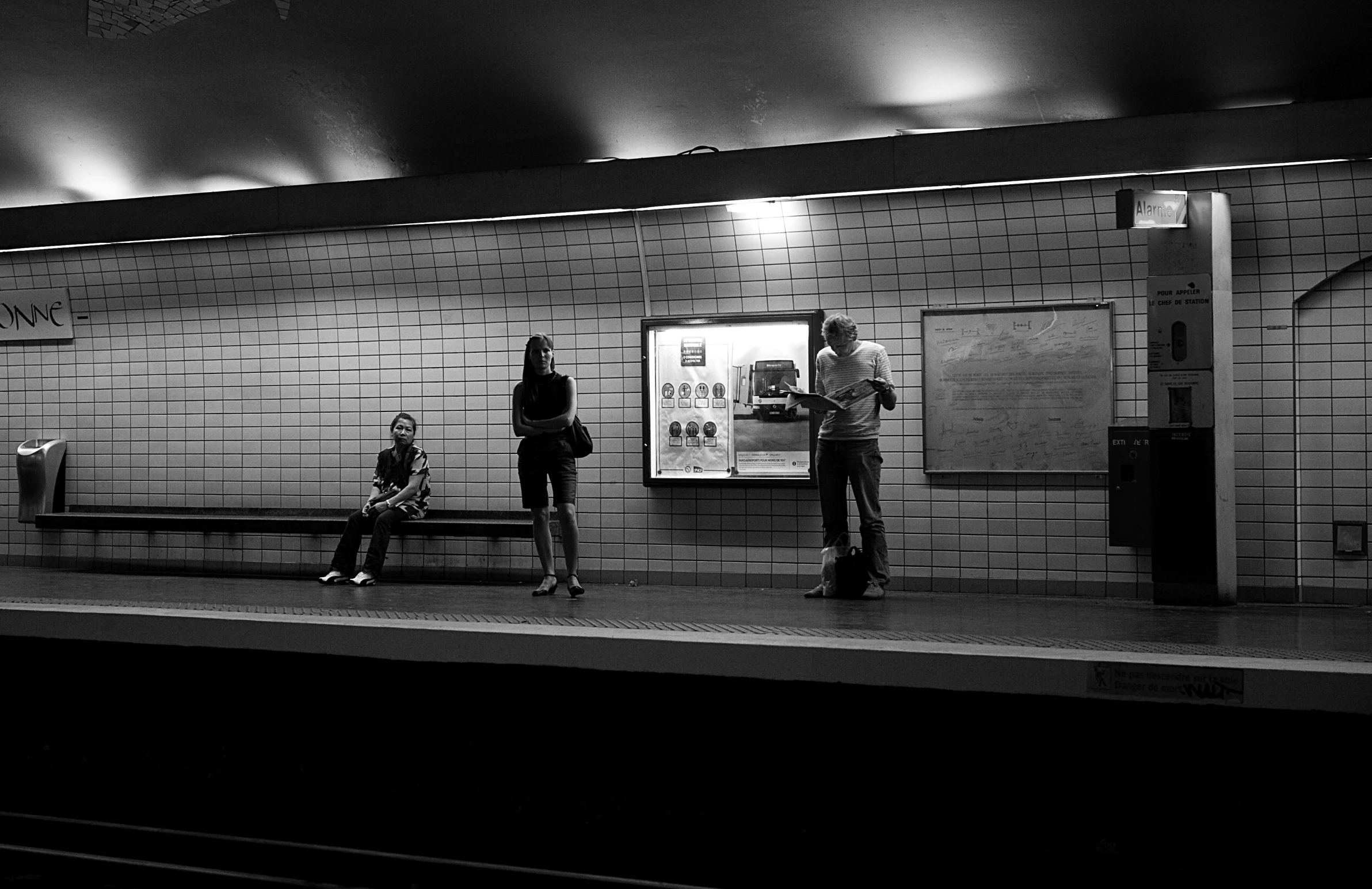 people wait to get off the subway at night